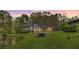 Charming home featuring a well-manicured lawn, mature trees, and a serene pond, perfect for outdoor enjoyment at 6585 Queen Mill Se Rd, Mableton, GA 30126