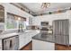 Spacious kitchen features white cabinets, stainless steel appliances, and ample counter space at 6585 Queen Mill Se Rd, Mableton, GA 30126
