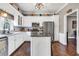 Modern kitchen with white cabinets, stainless steel appliances, a center island, and hardwood floors at 6585 Queen Mill Se Rd, Mableton, GA 30126