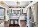 Well-lit kitchen with stainless steel appliances, white cabinets, and a cozy breakfast bar at 6585 Queen Mill Se Rd, Mableton, GA 30126