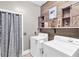 Bright laundry room with modern appliances, wooden accents, and functional storage solutions provides a practical and stylish space at 6585 Queen Mill Se Rd, Mableton, GA 30126