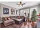 Spacious living room boasts hardwood floors, comfortable seating, and large windows overlooking the yard at 6585 Queen Mill Se Rd, Mableton, GA 30126