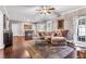 Spacious living room with hardwood floors, a cozy sectional, and French doors leading to the outside at 6585 Queen Mill Se Rd, Mableton, GA 30126