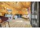 Unique interior space with wood paneling, fireplace, piano, sofa, and laminate flooring at 6585 Queen Mill Se Rd, Mableton, GA 30126