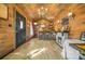 Unique interior featuring a bar with a stone fireplace, wood paneling, and laminate flooring at 6585 Queen Mill Se Rd, Mableton, GA 30126