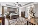 Elegant main bedroom features hardwood floors, a tray ceiling, large windows, and an ensuite bathroom at 6585 Queen Mill Se Rd, Mableton, GA 30126