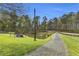 Scenic view of the property's pond with a fountain, surrounded by lush greenery at 6585 Queen Mill Se Rd, Mableton, GA 30126