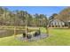 Outdoor seating area with a fire pit overlooking a tranquil pond at 6585 Queen Mill Se Rd, Mableton, GA 30126