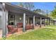 Inviting porch with cozy seating area and outdoor kitchen space at 6585 Queen Mill Se Rd, Mableton, GA 30126