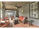 Relaxing porch with comfortable seating, ceiling fan, and outdoor view at 6585 Queen Mill Se Rd, Mableton, GA 30126