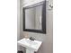 Elegant powder room features a pedestal sink, framed mirror, and neutral color palette, creating a sophisticated and functional space at 6585 Queen Mill Se Rd, Mableton, GA 30126