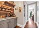 Rustic wet bar with wood accents, shelving, and coffee machines for a cozy feel at 6585 Queen Mill Se Rd, Mableton, GA 30126