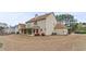 Spacious home with a well-maintained lawn, covered patio, and landscaped flowerbeds in the backyard at 122 Crestmont Dr, Canton, GA 30114