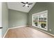 A bright bedroom with vaulted ceilings, neutral walls, a large window, and light-colored hardwood flooring at 122 Crestmont Dr, Canton, GA 30114