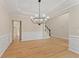 Open dining area with hardwood floors, wainscoting, and staircase access at 122 Crestmont Dr, Canton, GA 30114