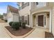 Exterior view of a beige two-story house featuring dark shutters and front door at 122 Crestmont Dr, Canton, GA 30114