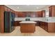 The kitchen features cherry wood cabinets, stainless steel appliances, an island, and light-colored hardwood floors at 122 Crestmont Dr, Canton, GA 30114