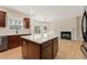 The kitchen features stainless steel appliances, an island, cherry wood cabinets, white countertops, and light-colored hardwood floors at 122 Crestmont Dr, Canton, GA 30114