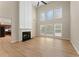 Open-concept living room features vaulted ceilings, a modern fireplace, large windows, and light-colored hardwood flooring at 122 Crestmont Dr, Canton, GA 30114