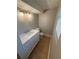 Bathroom featuring an elegant white vanity with marble countertop, modern lighting fixtures, and window with blinds at 1464 Colony East Cir, Stone Mountain, GA 30083