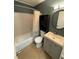 Clean and updated bathroom with neutral tile, a shower/tub combo, and a modern vanity with stylish fixtures at 1464 Colony East Cir, Stone Mountain, GA 30083