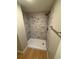 Close-up of the modern shower in the updated bathroom, highlighting the marble-look tile and sleek shower fixtures at 1464 Colony East Cir, Stone Mountain, GA 30083