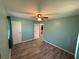 Bright bedroom with a ceiling fan, light green walls, plank flooring, and a spacious closet at 1464 Colony East Cir, Stone Mountain, GA 30083