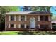 Charming brick home featuring a well-maintained lawn, white shutters, and a classic front door at 1464 Colony East Cir, Stone Mountain, GA 30083