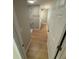 Hallway view leading to the updated bathroom with shower featuring modern marble-look tile and sleek fixtures at 1464 Colony East Cir, Stone Mountain, GA 30083