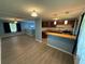 Open concept living room features new floors, neutral paint, and updated kitchen with breakfast bar at 1464 Colony East Cir, Stone Mountain, GA 30083