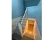 Stairway leading to the basement with white-painted banisters and light-colored walls at 1464 Colony East Cir, Stone Mountain, GA 30083