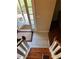 Tiled entryway with a light fixture switch upon entrance featuring the staircase with wooden steps at 230 Blue Heron Dr, Jonesboro, GA 30238