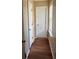 Hallway with wood-look flooring featuring a window with blinds and two doors at 230 Blue Heron Dr, Jonesboro, GA 30238
