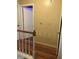 Upstairs hallway featuring wood-look floors, baseboard, and a view of the hall and door at 230 Blue Heron Dr, Jonesboro, GA 30238