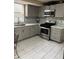 Modern kitchen with gray cabinets, stainless steel appliances, and subway tile backsplash at 230 Blue Heron Dr, Jonesboro, GA 30238