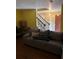 Cozy living room with wood floors, a comfortable couch, and a staircase at 230 Blue Heron Dr, Jonesboro, GA 30238