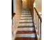 View of the staircase with painted white risers and wooden treads leading to an upstairs door at 230 Blue Heron Dr, Jonesboro, GA 30238