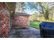 Brick exterior of home leading out to a concrete patio and backyard at 2442 Wentworth Ne Dr, Atlanta, GA 30345
