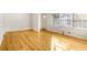 Open living room with hardwood floors, large windows, and neutral walls at 2442 Wentworth Ne Dr, Atlanta, GA 30345