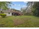 Expansive backyard with lush green grass, mature trees, and a view of the home's exterior at 4606 Greensprings Rd, College Park, GA 30337