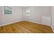 Bright bedroom with hardwood floors, two windows and neutral walls provides a serene atmosphere at 4606 Greensprings Rd, College Park, GA 30337