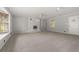 Spacious living room is equipped with a cozy white brick fireplace and neutral carpet at 4606 Greensprings Rd, College Park, GA 30337