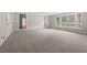 Large living room features a white brick accent wall, new carpet, and natural light through large windows at 4606 Greensprings Rd, College Park, GA 30337