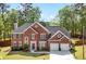 A lovely two-story red brick home with well-maintained landscaping, a driveway, and a basketball hoop at 5296 Camden Lake Nw Pkwy, Acworth, GA 30101