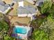 Aerial view of the backyard showing a spacious lawn, patio, and pool surrounded by lush greenery and a wooden fence at 5296 Camden Lake Nw Pkwy, Acworth, GA 30101