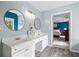Well-lit bathroom boasts dual sinks with gold fixtures and a view into the Primary bedroom at 5296 Camden Lake Nw Pkwy, Acworth, GA 30101