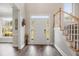 Bright foyer with hardwood floors, a staircase with white railing and a light-filled entry with a large window at 5296 Camden Lake Nw Pkwy, Acworth, GA 30101