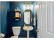 Charming half bathroom with blue accent wall, pedestal sink, and decorative shelves at 5296 Camden Lake Nw Pkwy, Acworth, GA 30101