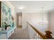 Bright upstairs hallway with elegant lighting fixture at 5296 Camden Lake Nw Pkwy, Acworth, GA 30101