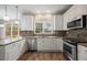 Updated kitchen featuring stainless steel appliances, granite countertops, and plenty of natural light at 5296 Camden Lake Nw Pkwy, Acworth, GA 30101